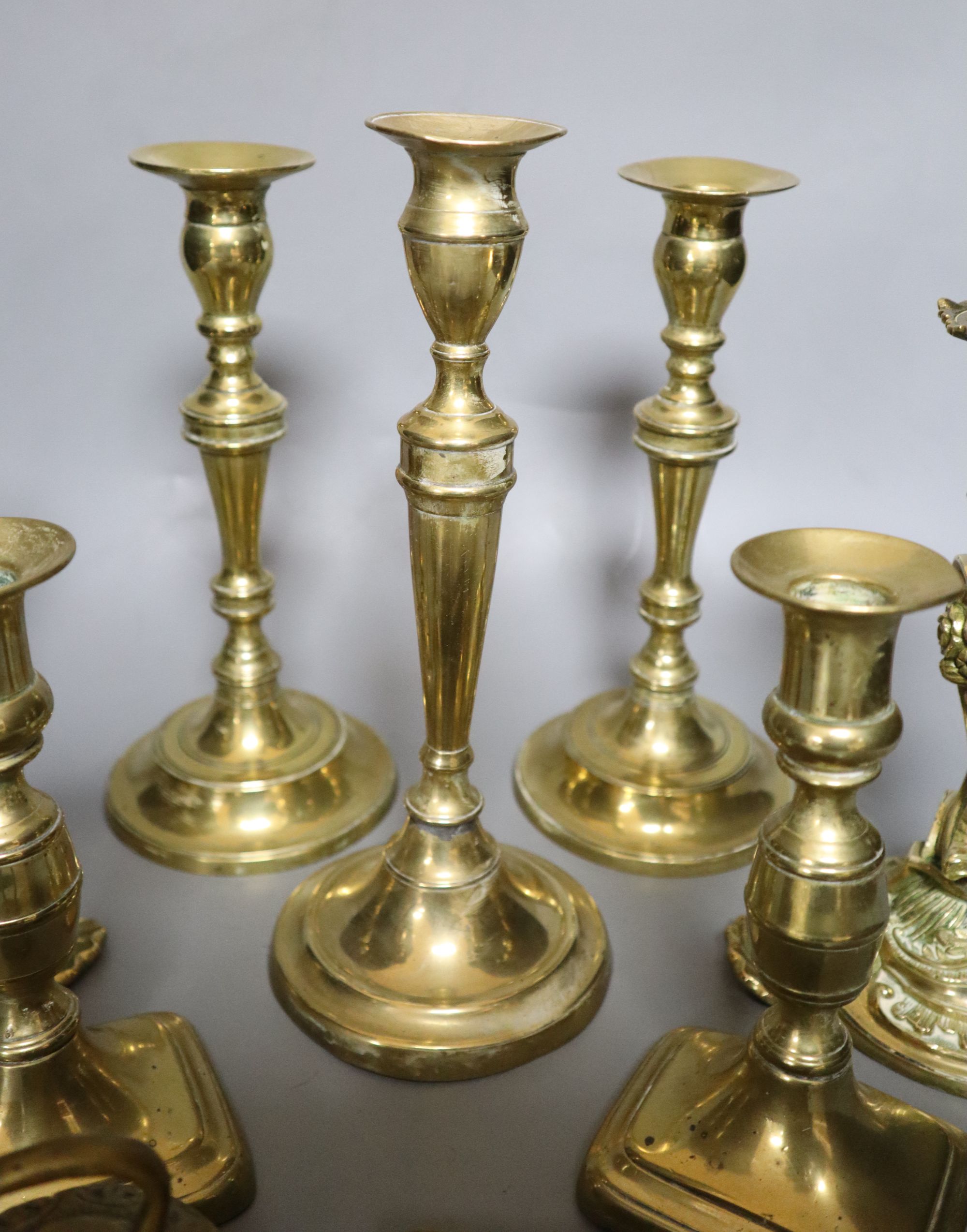 A group of brassware including candlesticks